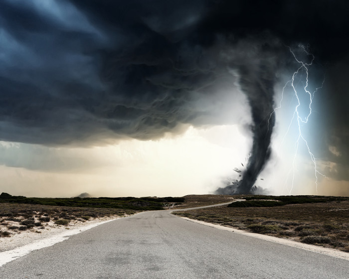 Powerful tornado and lightning above countryside road